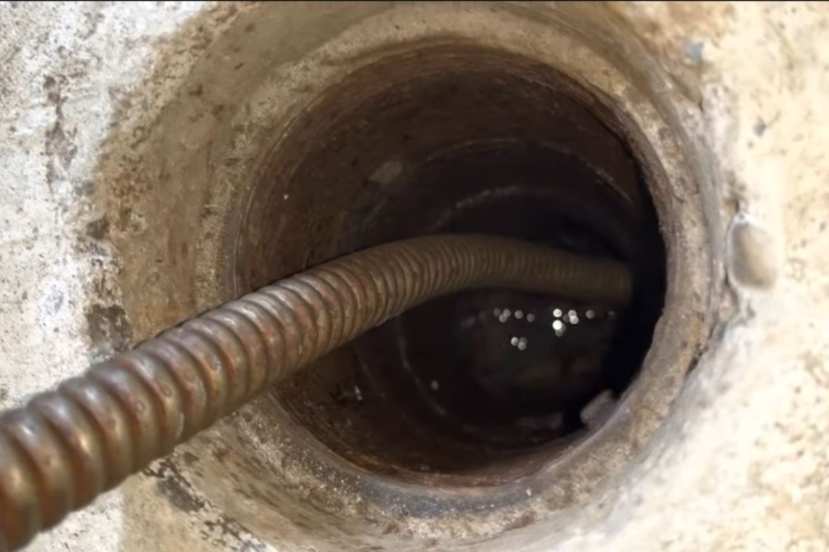 Kent Apex Plumbing technician clearing a drain in Kent, WA
