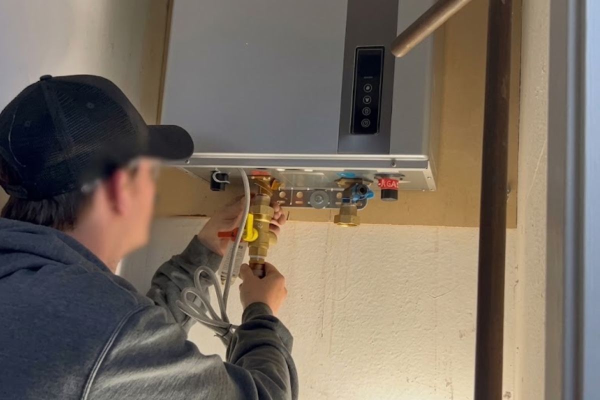 Kent Apex Plumbing technician installing a water heater in Kent, WA